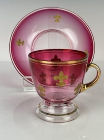 A GILT BACCARAT CUP AND SAUCER
