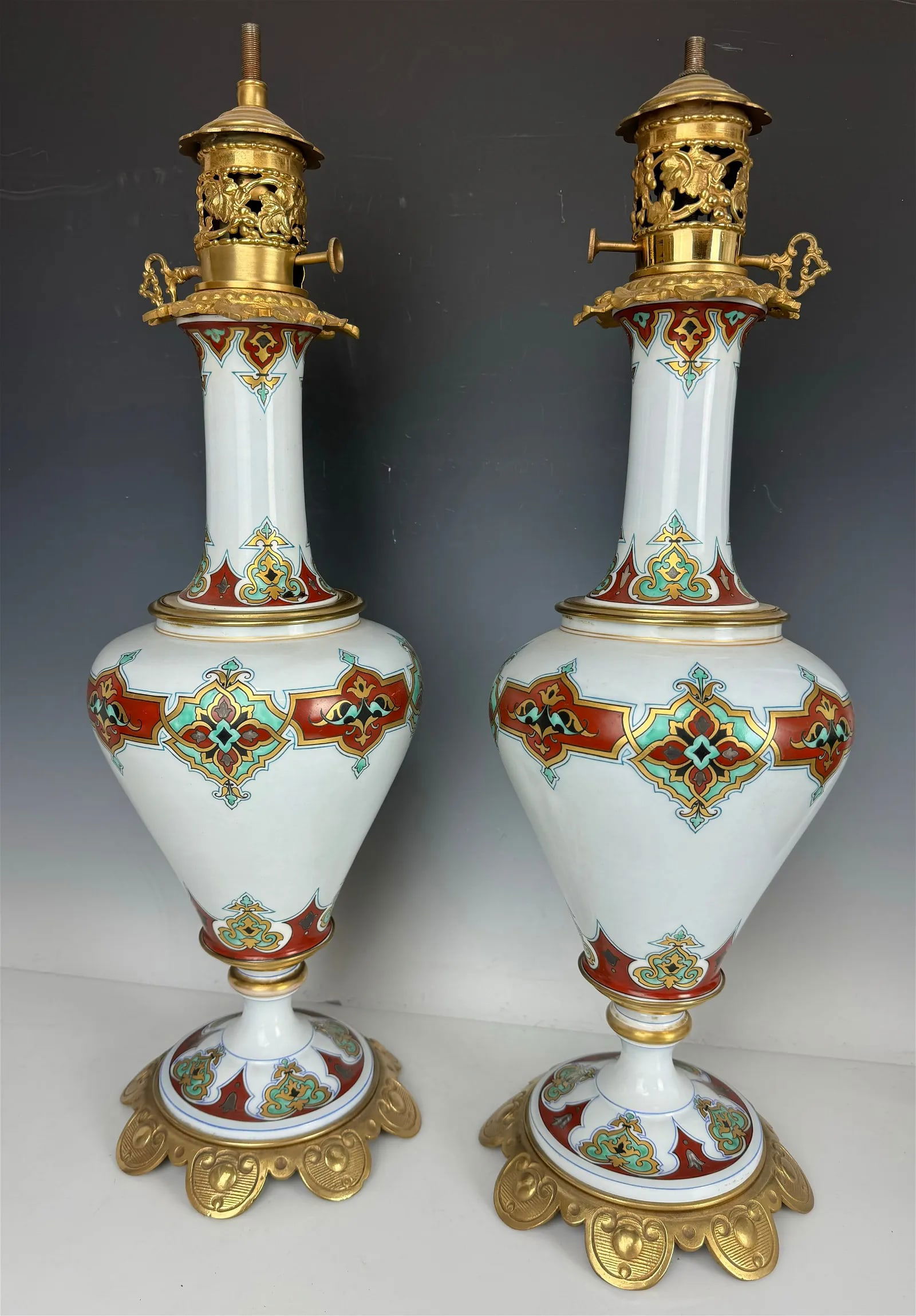 A PAIR OF FRENCH PORCELAIN AND ORMOLU VASES/LAMPS: Circa 1900. Measure 24 inches tall. In good condition. Needs retiring. Estimate $1.500-2.000