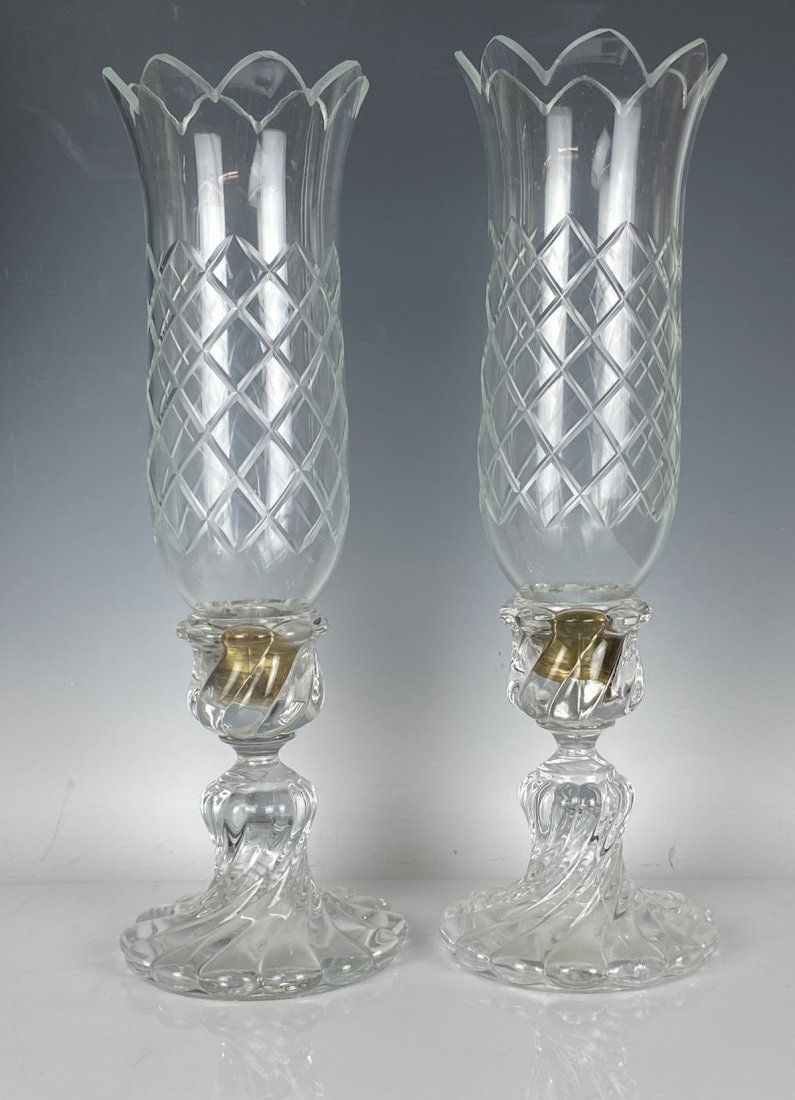 A PAIR OF BACCARAT HURRICANE LAMPS: Measure 18 inches tall. Bases signed Baccarat. In good condition. Estimate $800-1.000