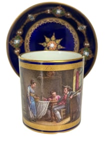 A MAGNIFICENT JEWELLED SEVRES CUP AND SAUCER