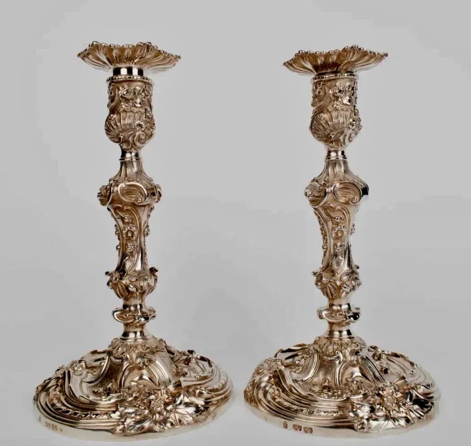 PAIR OF STERLING CANDEL HOLDERS BY ROBERT ROSKELL, ALAN & JOHN MORTIMER HUNT: Silver candlestick made in London in 1888 by the silversmithsRobert Roskell, Alan & John Mortimer Hunt .Measure 10 inches h. And weighs approx 2044 grams. Excellent condition. Estimate $6000-8000