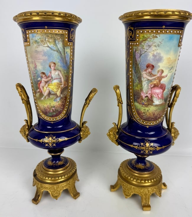 A PAIR OF ORMOLU MOUNTED SEVRES PORCELAIN VASES: Circa 1900. Measure 8.5 inches h. No damage detected. Estimate $500-600