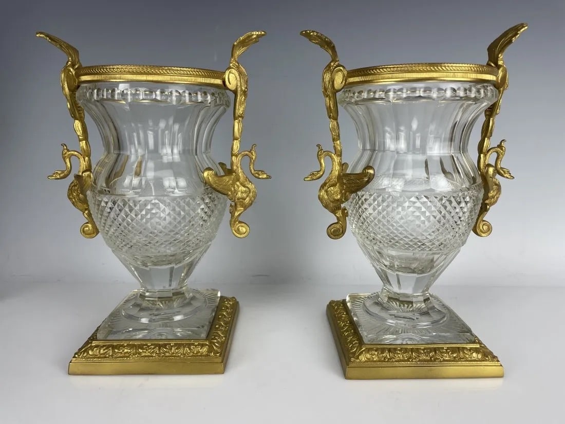 A PAIR OF EMPIRE STYLE DORE BRONZE AND BACCARAT CRYSTALVASES: Circa 1900. Measure 8.5 inches tall. In good antique condition. Estimate $2.000-2.500