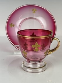 A GILT BACCARAT CUP AND SAUCER