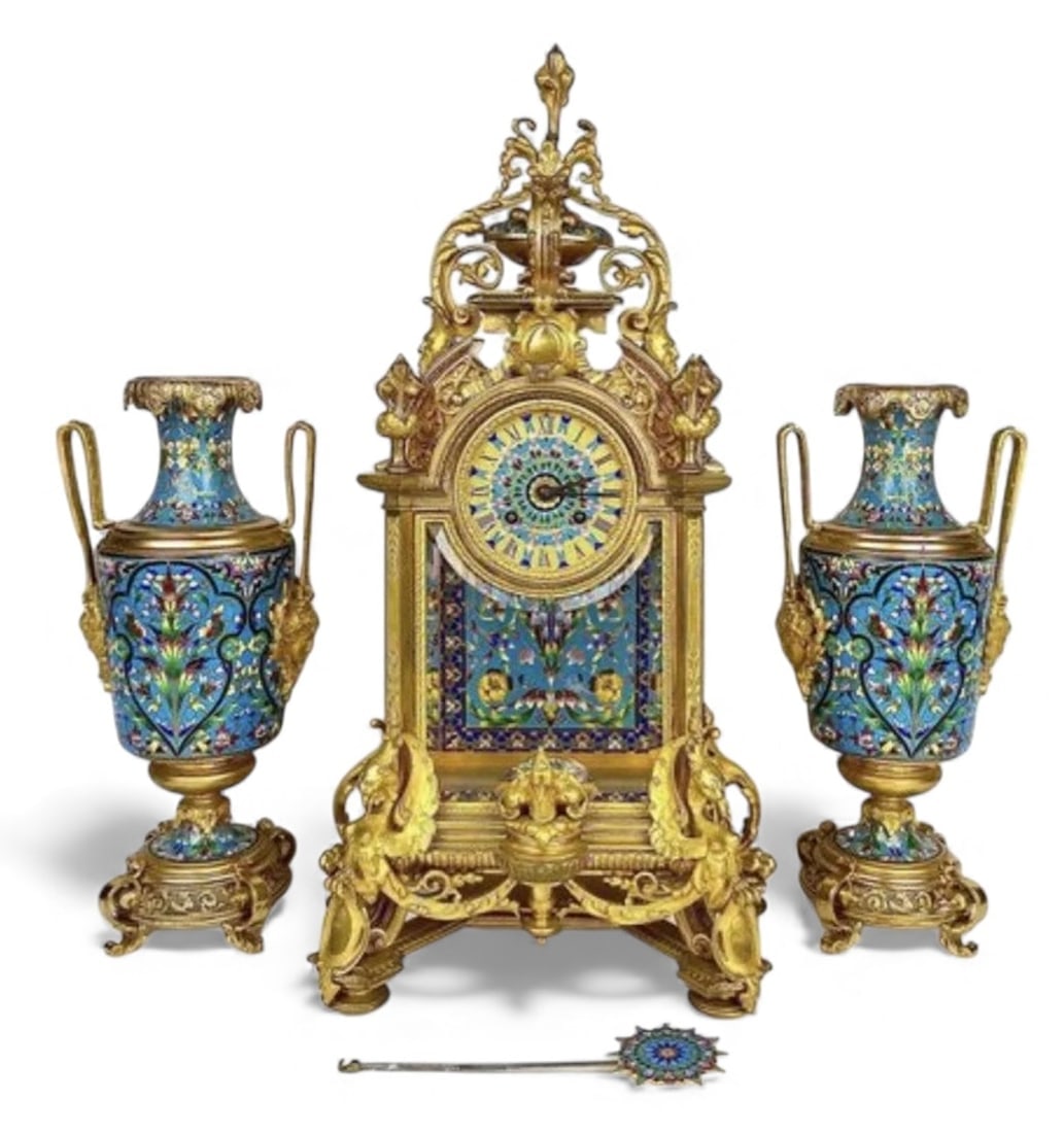 A MAGNIFICENT FRENCH CHAMPLEVE ENAMEL CLOCK SET: An imposing gilt bronze and CHAMPLEVE enamel clock set, attributed to F. BARBEDIENNE , Clock. Estimate $30000-40000