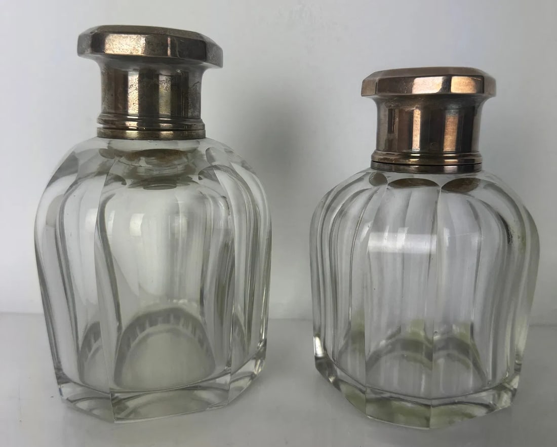 2 BACCARAT CRYSTAL AND STERLING SILVER PERFUME BOTTLES: Circa 1930. Largest 6 inches h. In perfect condition. Estimate $600-800