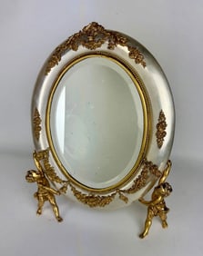 A VERY UNUSUAL GILT AND SILVERED ORMOLU MIRROR