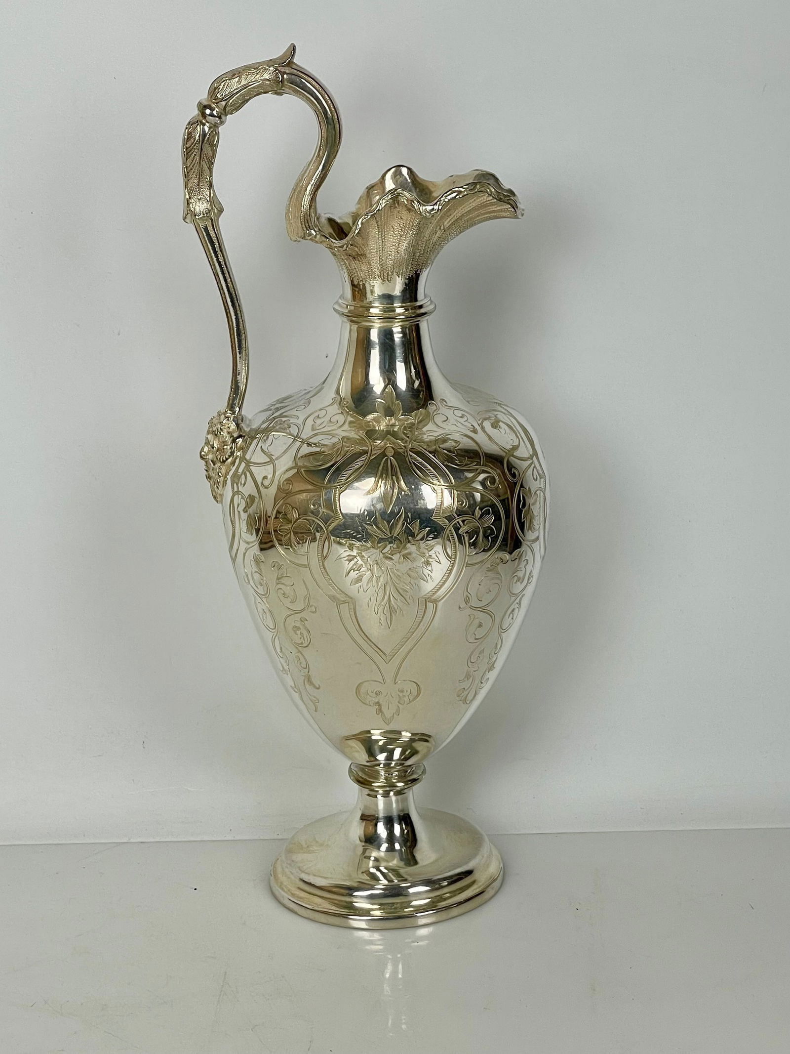 A LARGE SILVER PLATED EWER CIRCA 1900: Measures 10 inches tall, in good condition. Estimate $300-400
