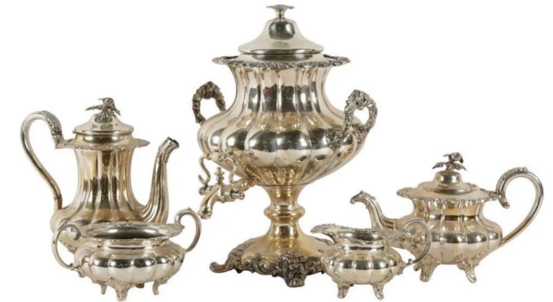 SILVERPLATE TEA AND COFFEE SERVICE: comprising a hot water urn (16 1/2 inches high); a coffee pot (10 inches high); a teapot (7 1/4 inches high); a covered sugar (6 inches high); and a creamer (4 inches high)Estimate $500-600