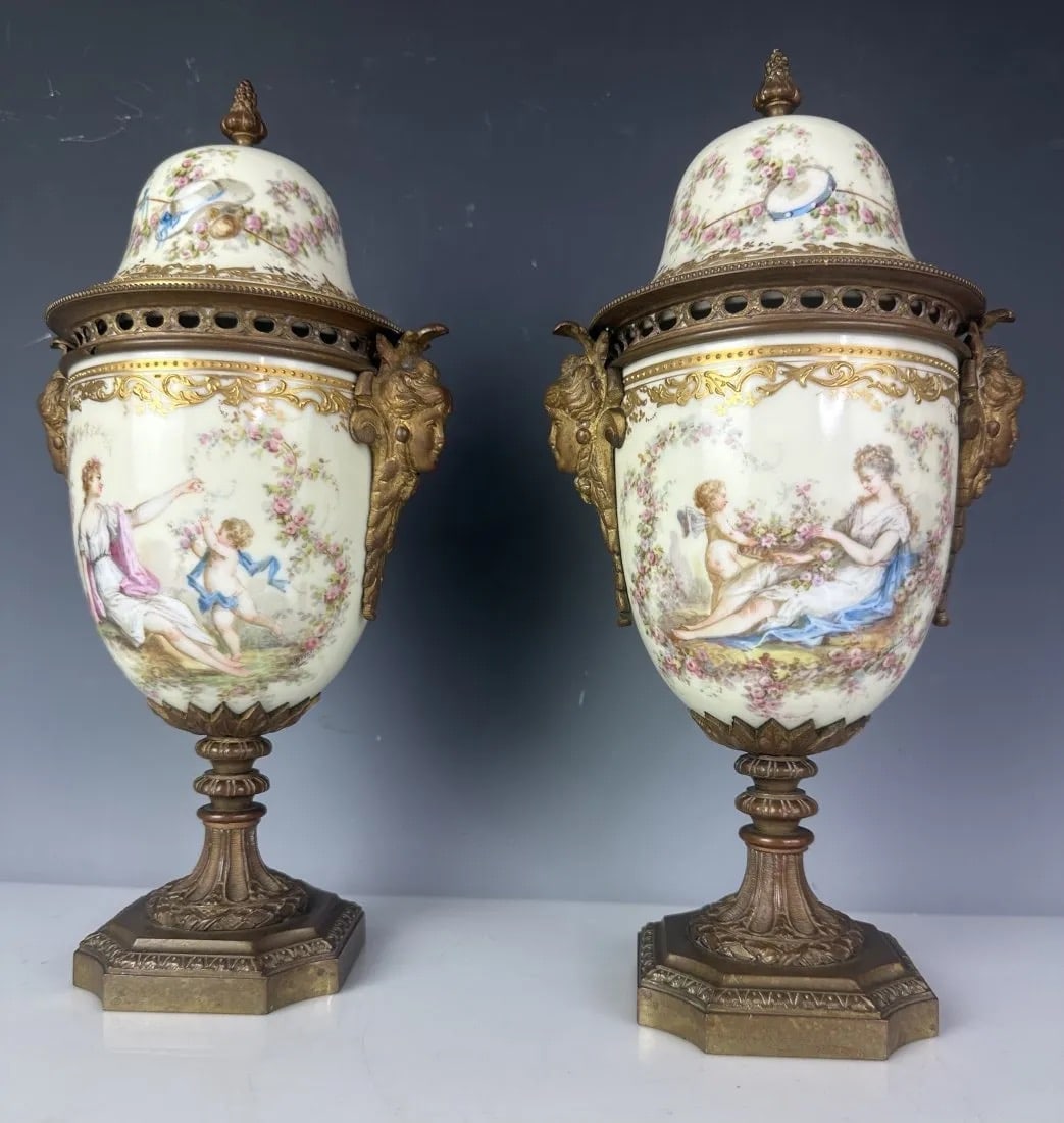 A PAIR OF ORMOLU MOUNTED SEVRES PORCELAIN VASES: Circa 1900. Measure 12 inches high. Good antique condition. Estimate $1.000-1.200