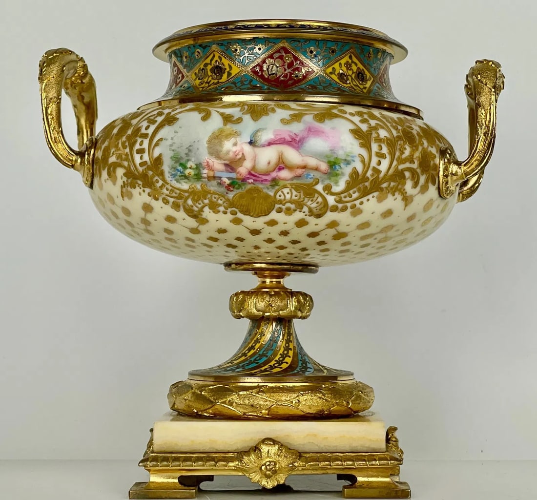 FRENCH CHAMPLEVE ENAMEL AND SEVRES PORCELAIN VASE: Circa 1900. In good condition. Estimate $1000-1200