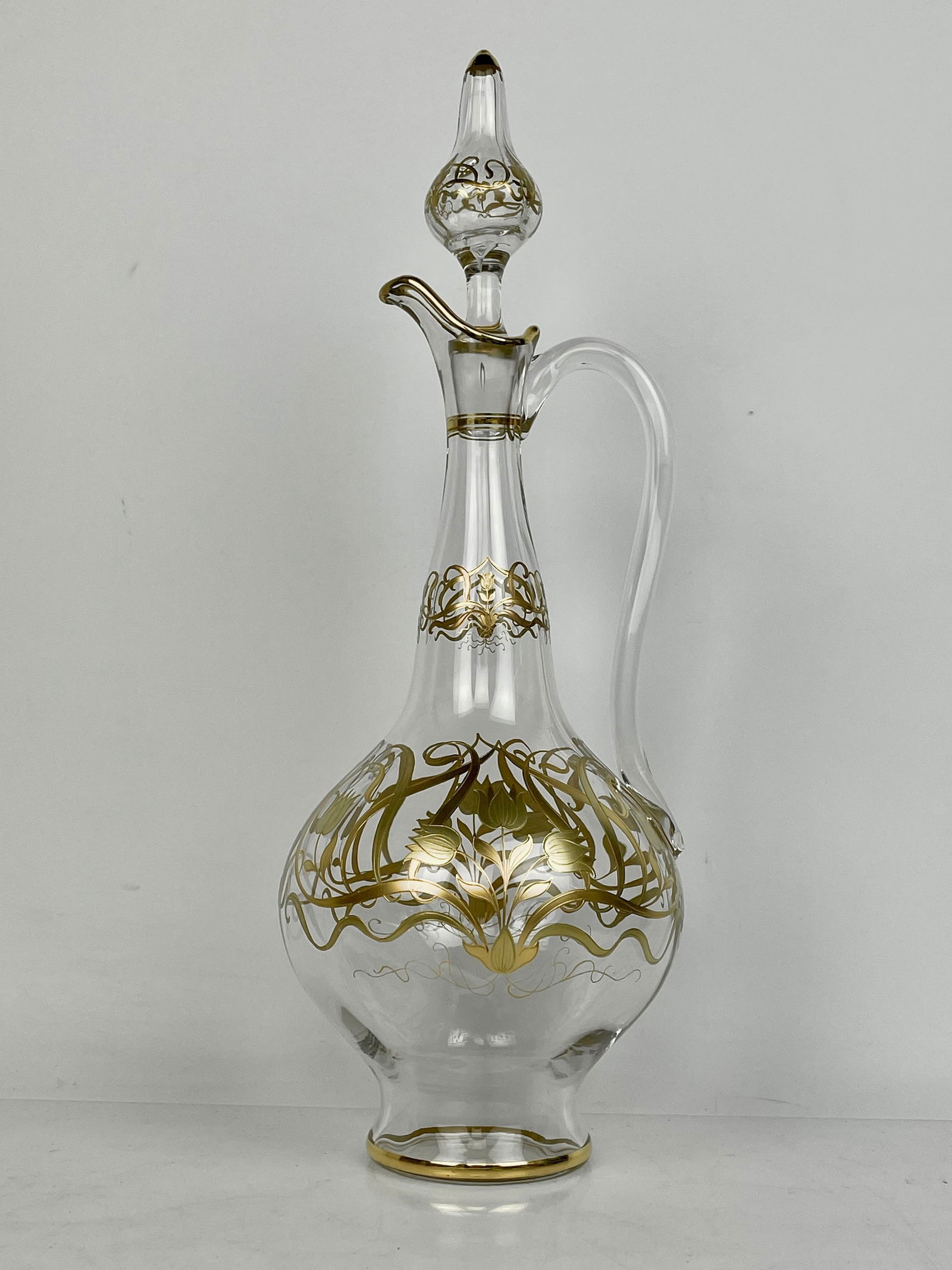 GILT AND ENAMELLED MOSER LIQUOR BOTTLE: Circa 1900, decorated in two color gold. Measures. 14.5 inches tall. Excellent condition. Estimate $500-600