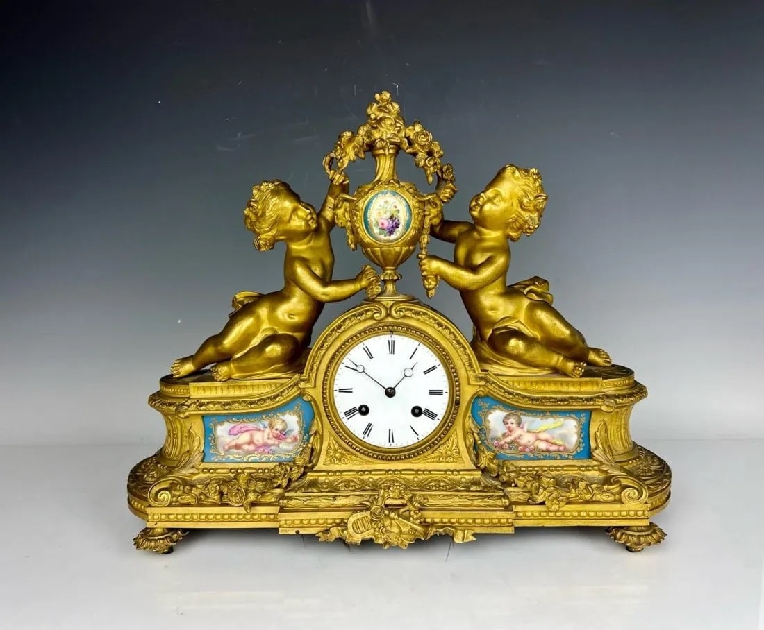 19TH C. FIGURAL DORE BRONZE AND SEVRES PORCELAIN CLOCK: Measures 14.5 inches h. , 18 inches w. In good condition. Movement not guaranteed to keep time. Estimate $2000-2500