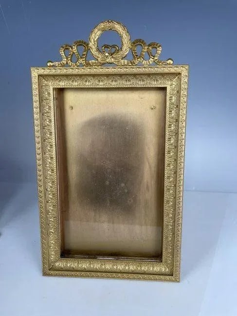 EMPIRE STYLE DORE BRONZE FRAME: Circa 1900. Measures 10 inches; x 6 inches;. In good condition. Estimate $1.000-1.200