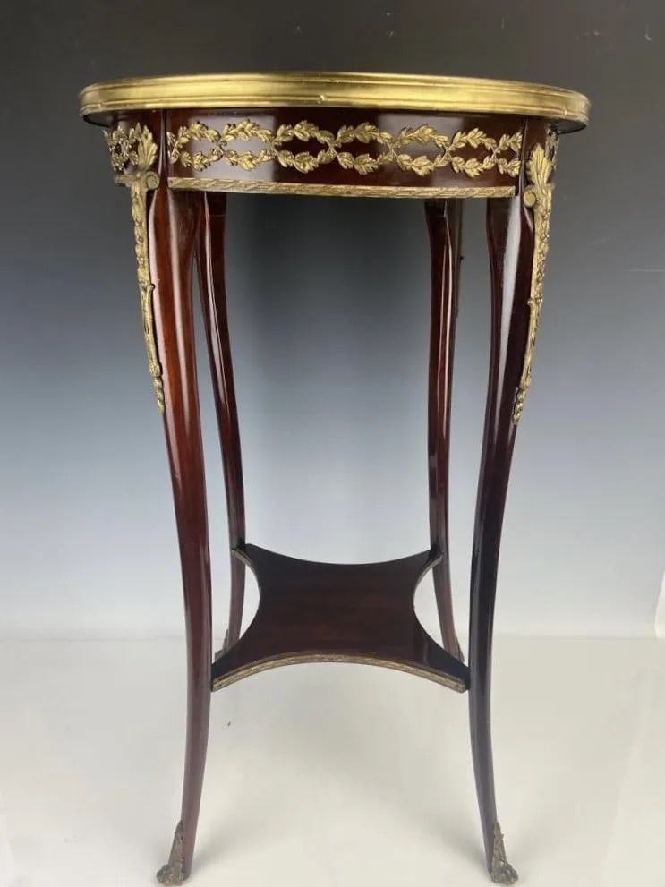 ORMOLU MOUNTED MARBLE TOP OCCASIONAL TABLE: Measures 17 inches d., 29 inches high. Estimate $800-1.000