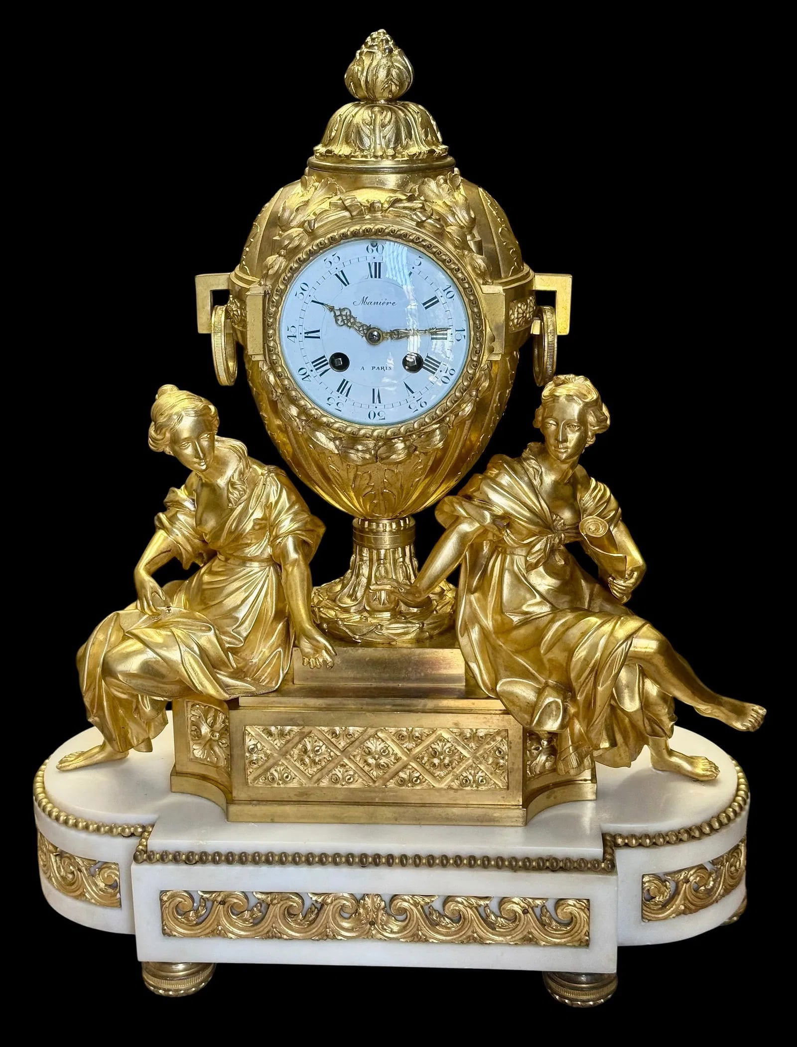 19TH C. BRONZE AND WHITE MARBLE FIGURAL CLOCK: A Louis XVI style gilt bronze and white marble figural mantel clockCharles-Guillaume Maniere, Parislate 19th centuryThe circular enamel dial with Roman hours and Arabic minutes inscribed Maniere / a P