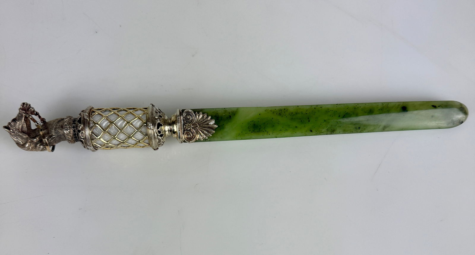 FABERGE STYLE SILVER GILT, ENAMEL AND NEPHRITE LETTER OPENER: SILVER GILT, ENAMEL AND NEPHRITE PAPER KNIFE. Comprising a finely crafted silver gilt, enamel and nephrite paper knife in the Fabergé style. The cylindrical handle with translucent mauve enamel over