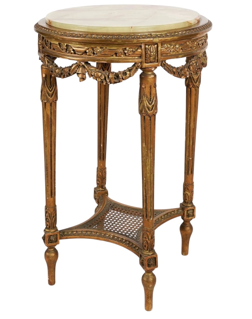 LOUIS XVI STULE GILT WOOD TABLE: Louis XVI style gilt wood table with inset onyx top and caned under shelf 31 1/2 x 20 in. (80.01 x 50.80 cm.). Estimate $800-1000