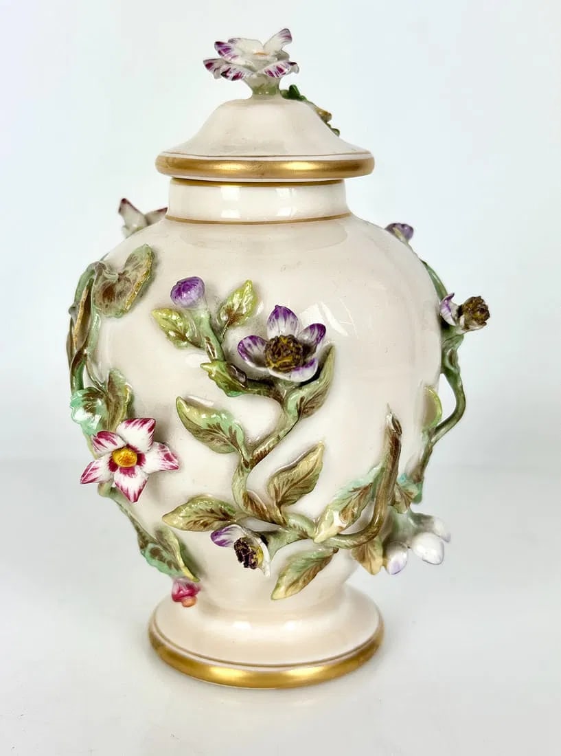 A FLOWER ENCRUSTED BERLIN KPM BOTTLE AND COVER: Circa 1900. Measures 5 inches tall. Estimate $300-400