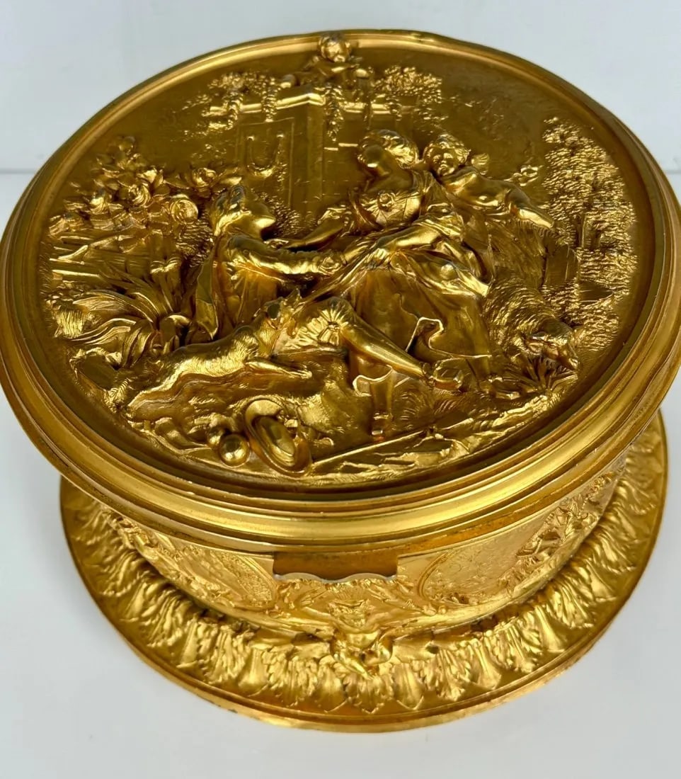 19TH C. ORMOLU JEWELLERY BOX: Measures 7 inches d., 6.8 inches high. In good antique condition. Estimate $1.000-1.200