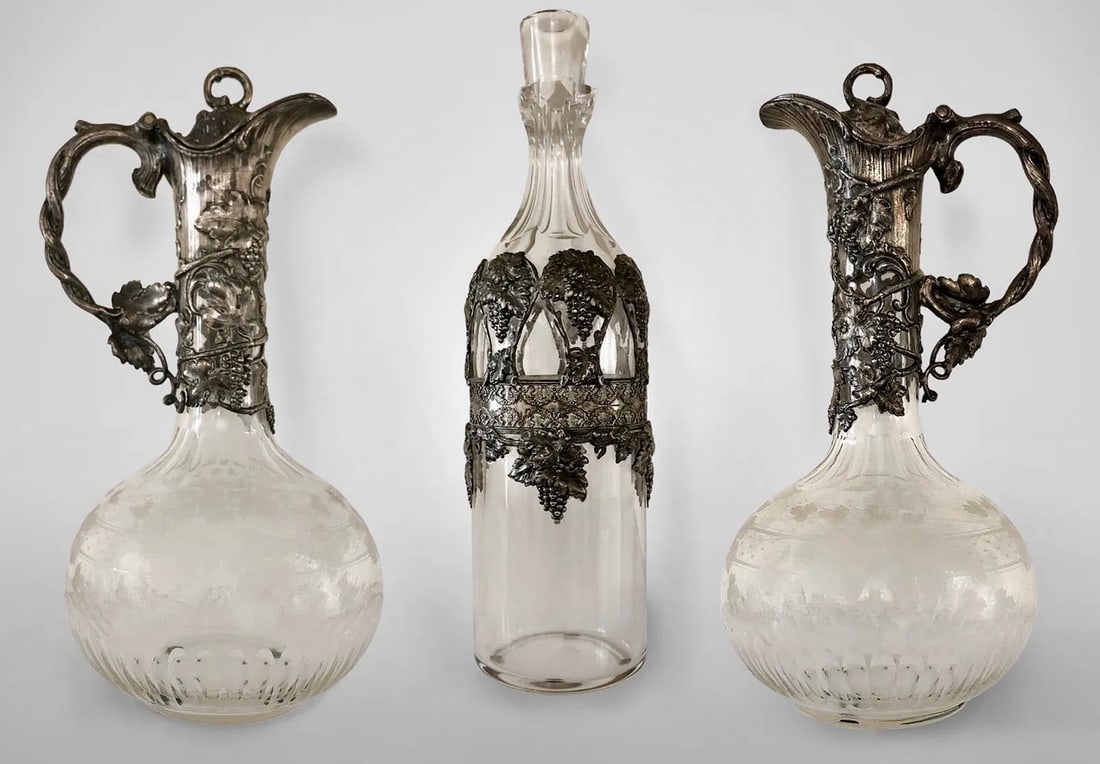 19TH C. CRYSTAL AND WMF TRIO: A pair of ewers 12 inches h. And a bottle 12 inches . H. In good condition. Estimate $2000-2500