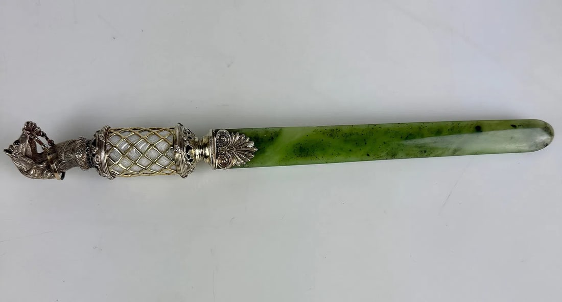 FABERGE STYLE SILVER GILT, ENAMEL AND NEPHRITE LETTER OPENER: SILVER GILT, ENAMEL AND NEPHRITE PAPER KNIFE. Comprising a finely crafted silver gilt, enamel and nephrite paper knife in the Fabergé style. The cylindrical handle with translucent mauve enamel over