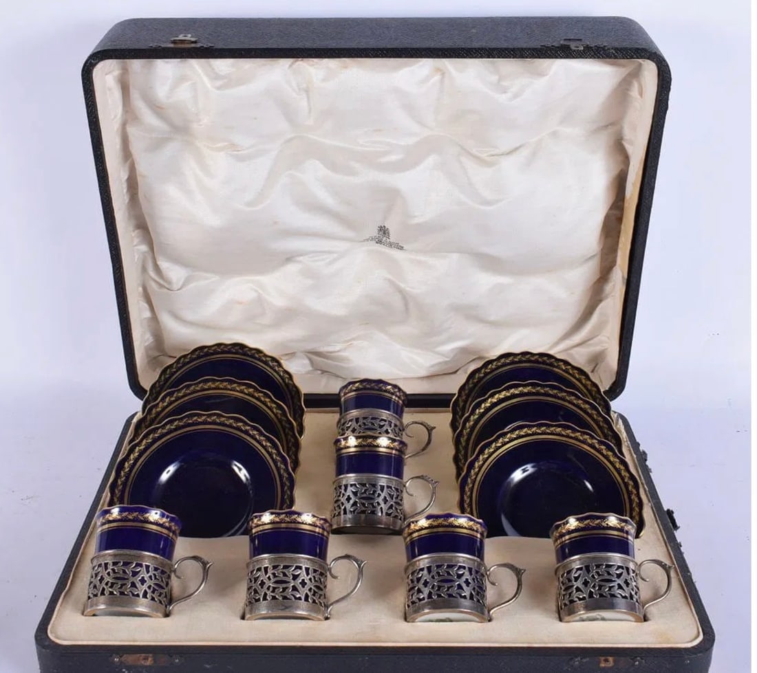 A CASED SET OF SILVER MOUNTED AYNSLEY COFFEE CUPS AND SAUCERS: A CASED SET OF SILVER MOUNTED AYNSLEY COFFEE CUPS AND SAUCERS. (12) Estimate $400-500