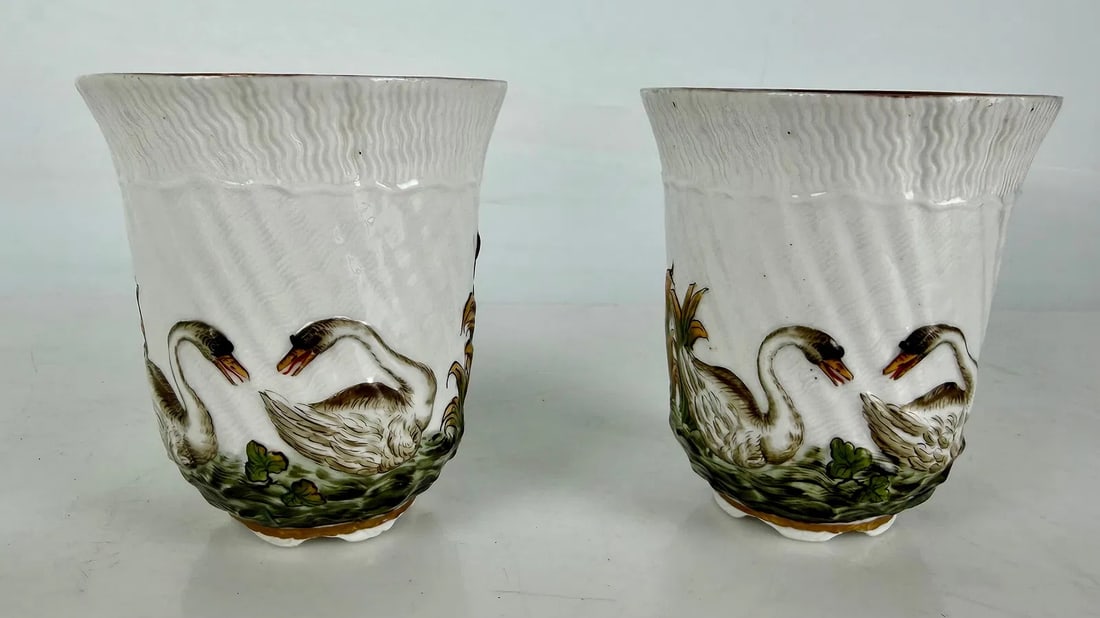 A PAIR MEISSEN TEA CUPS SWAN PATTERN: Circa 1900. Measure 4 inches h. In excellent condition. Estimate $500-600