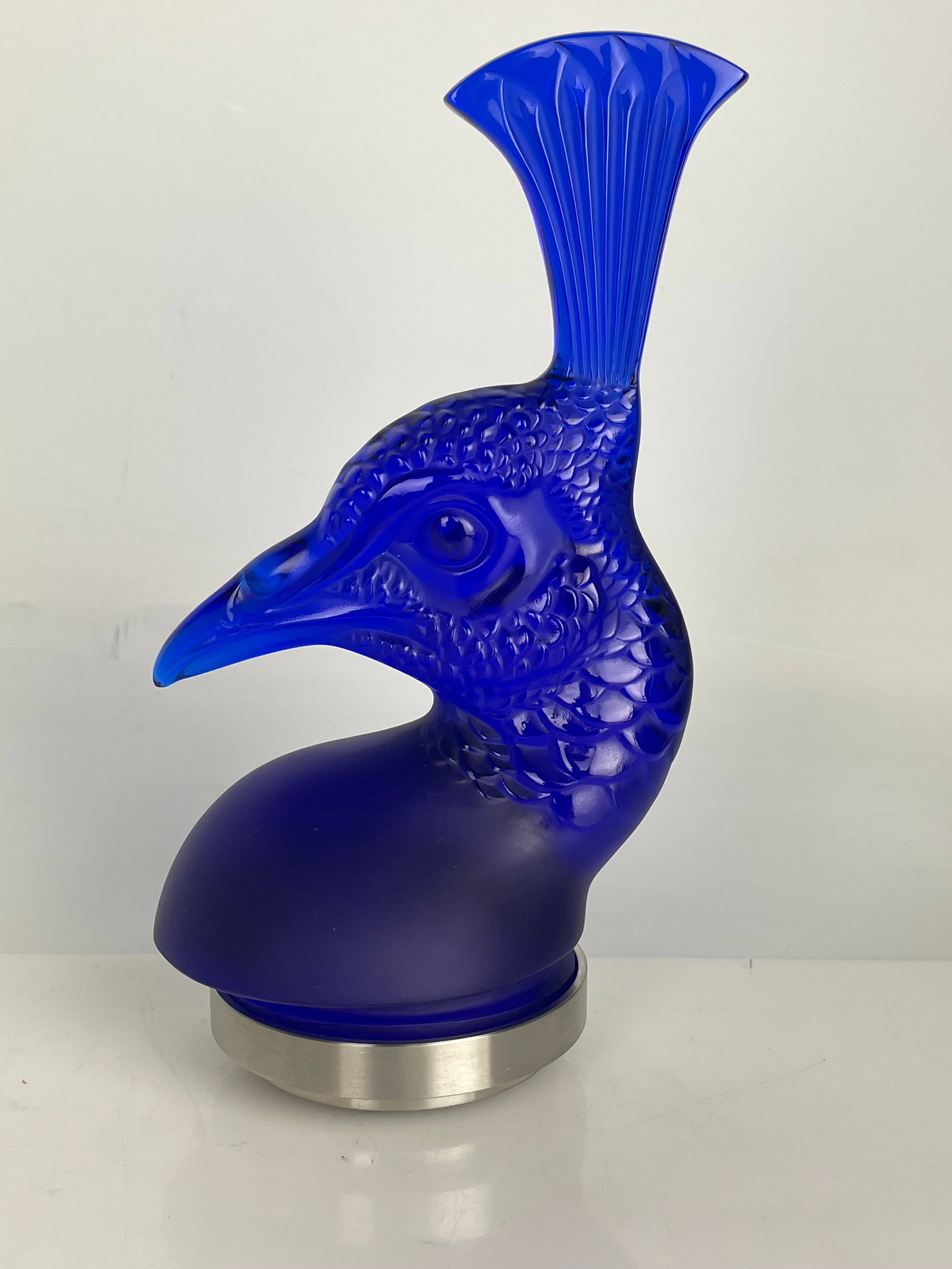 LALIQUE CRYSTAL PAPERWEIGHT: Lalique Crystal Paperweight Tete de Paon ornament of a peacock. Measures 7.5” h. Estimate $1000-1200