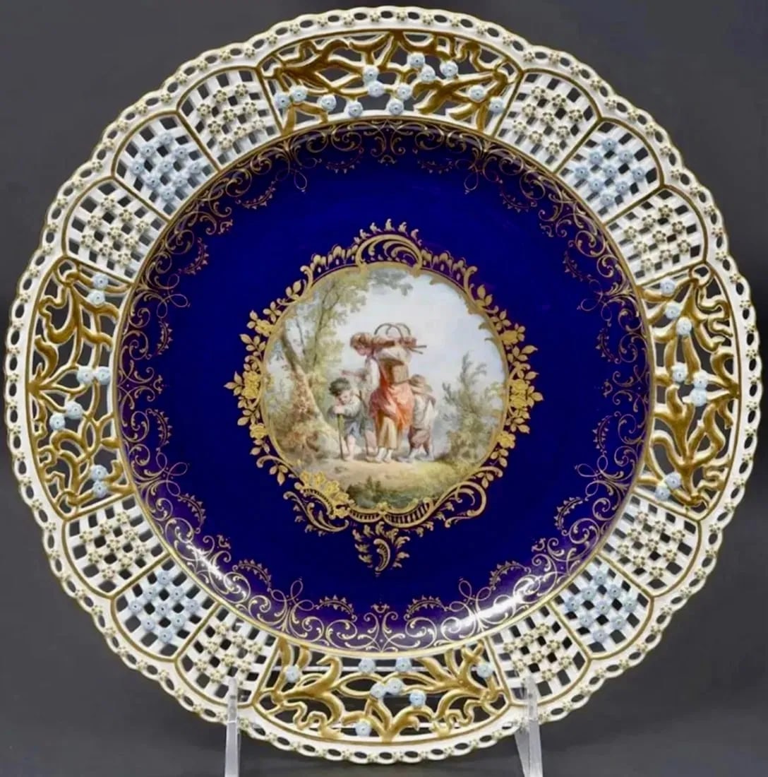 19TH C. RETICULATED MEISSEN PLATE: Painted with Watteau scene . Measures 9.5 inches d. Excellent antique condition. Estimate $2.000-2.500