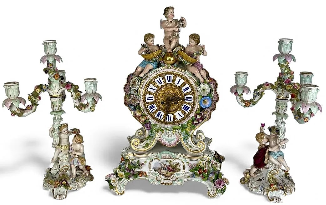 19TH C. MEISSEN CLOCK SET: First quality cross swords marks. Clock measures 20 inches high. In overall good condition, loss of flower petals, and professional restorations. Estimate $12000-15009