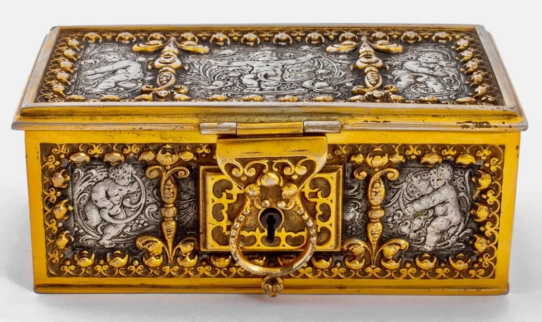 19TH C. ERHARD & SOHNE GILT AND SILVERED CASKET: Erhard & Sohne Gilt Silvered Bronze Jewelry Casket , circa 1895, maker's mark to underside, velvet-lined interior and with original key. 2.25" H x 5.5" W x 3.25" D. Estimate $1000-1200