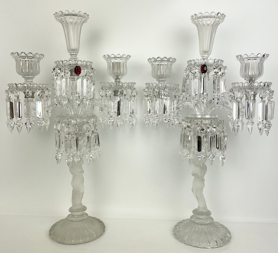 A LARGE PAIR OF BACCARAT ENFANT CANDELABLRA: Signed Baccarat. Measures 23 inches tall. In very good condition. Estimate $6000-8000