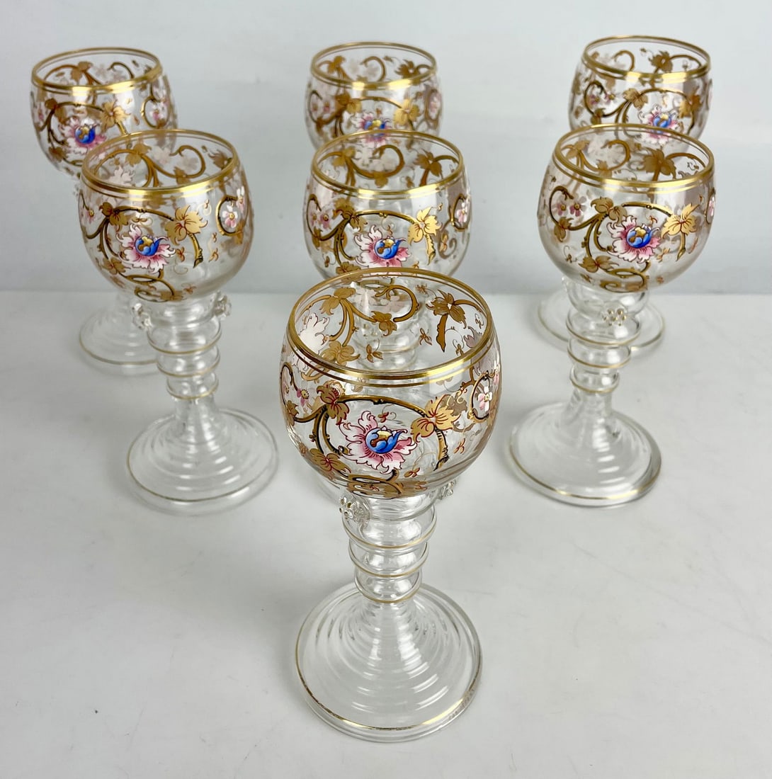 SET OF 7 GILT AND ENAMELED MOSER WINE GLASSES: Circa 1900. Measure 7 inches high. No damage detected. Estimate $600-800