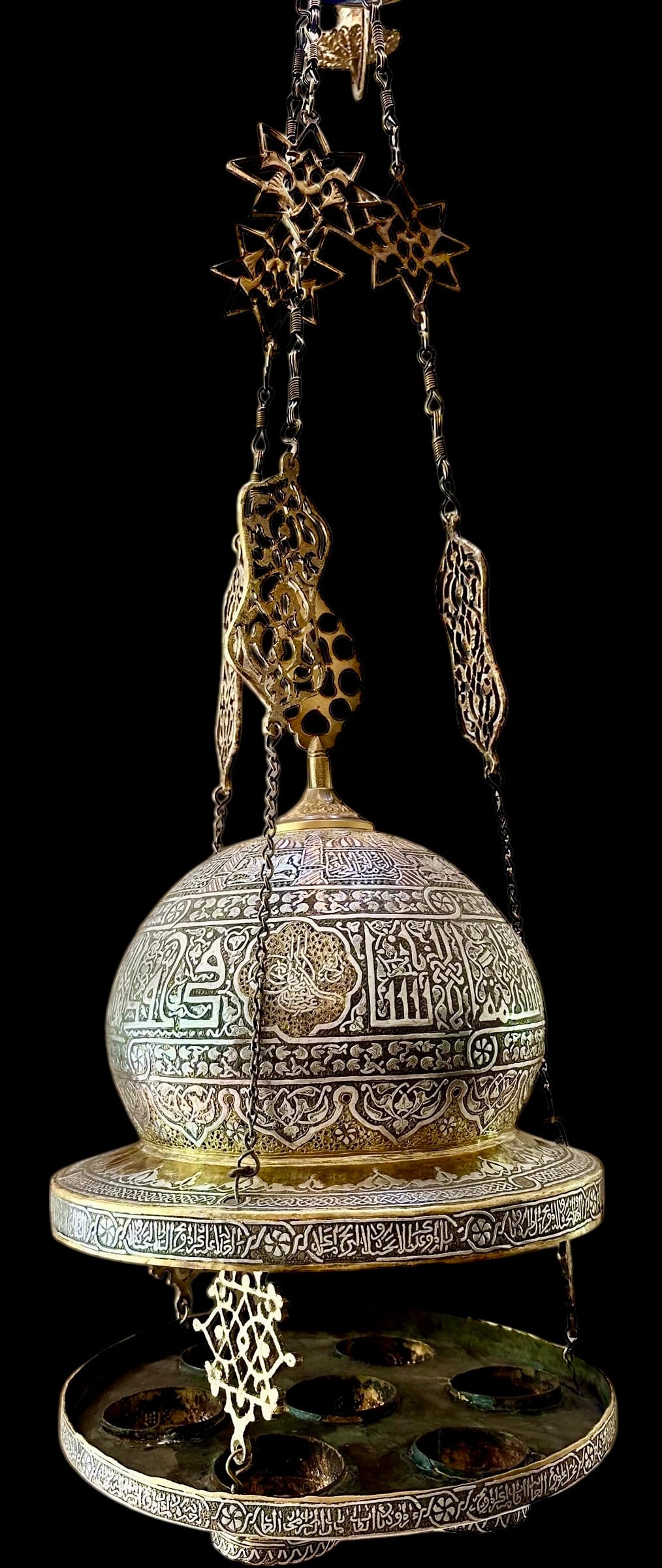 A MAGNIFICENT ISLAMIC SILVER INLAID MOSQUE LAMP: Circa 1880. With Arabic calligraphy all over and silver inlaid. In good antique condition. Estimate $12000-15000