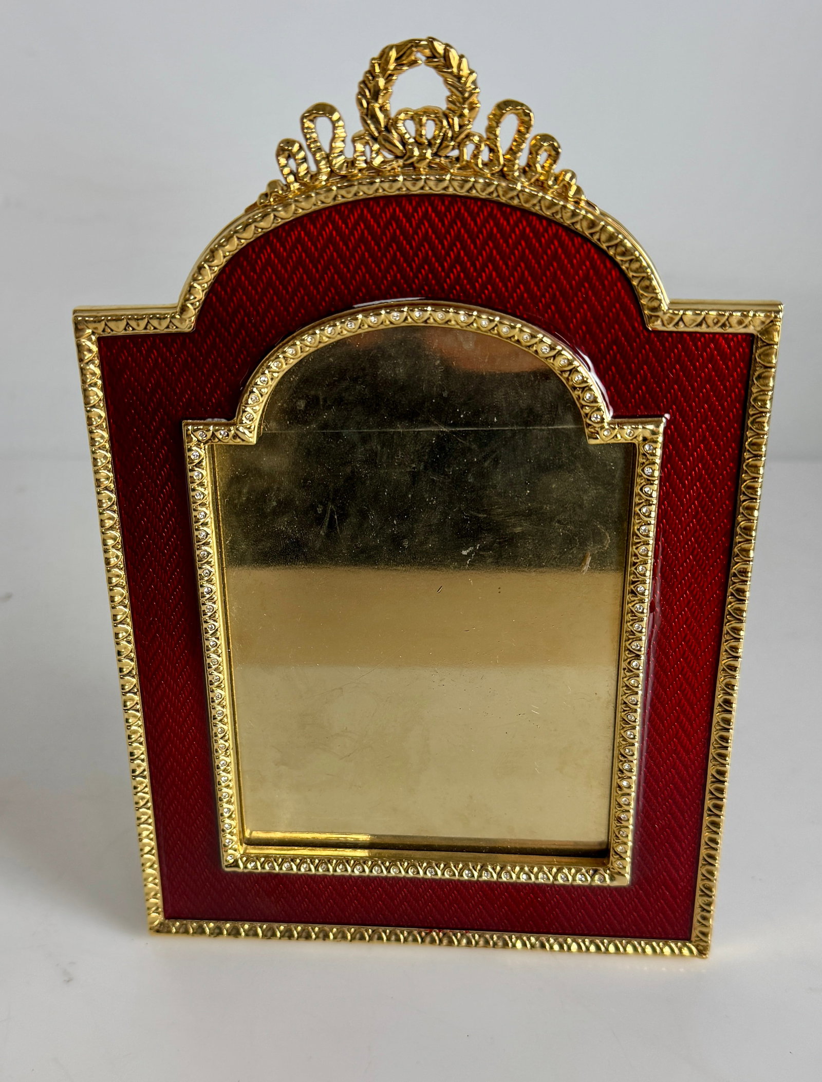 A LARGE IMPERIAL FABERGE ENAMELED PICTURE FRAME: Enameled in front and back of frame. Measures 8” high. In excellent condition. Estimate $800-1000