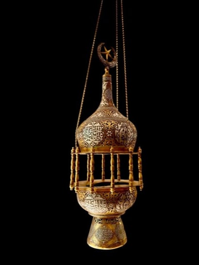 A MAGNIFICENT ISLAMIC SILVER INLAID MOSQUE LAMP: Circa 1900. Measures 35” h. In good condition. Estimate $15000-20000