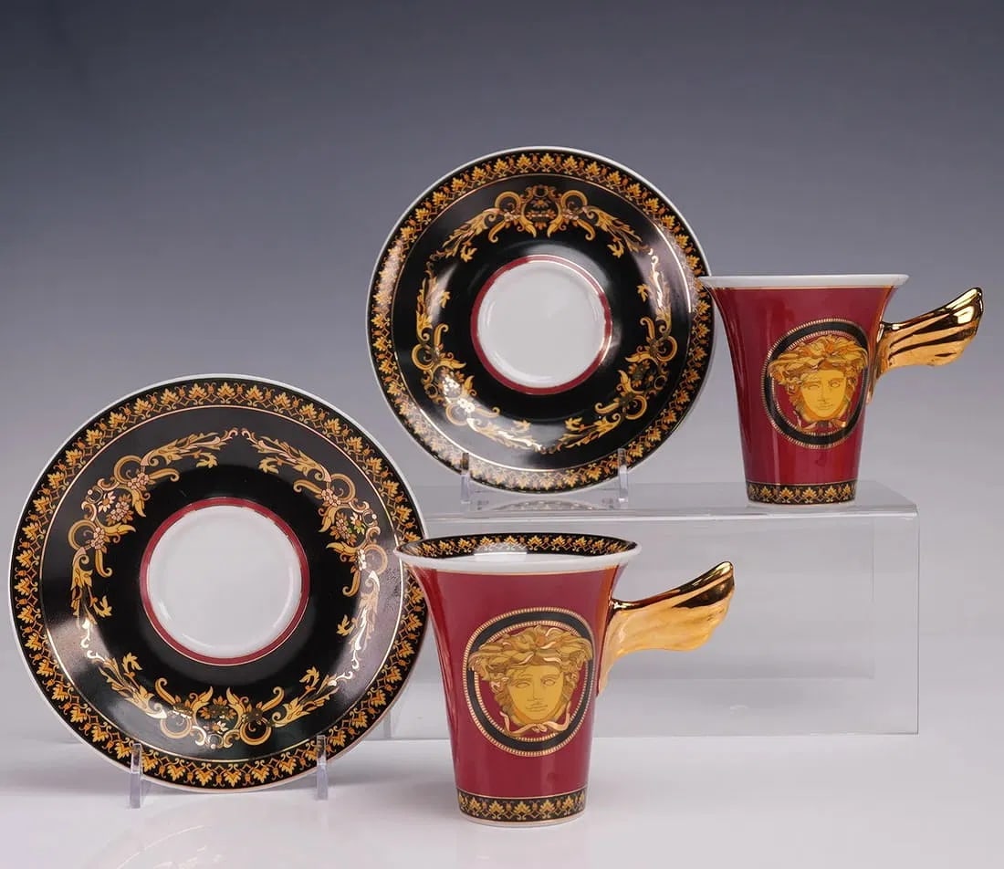A PAIR OF ROSENTHAL VERSACE CUP AND SAUCER: Each cup measures 4"L x 3.5"H. Each saucer measures 1"H x 6"dia. In excellent condition.Estimate $400-500