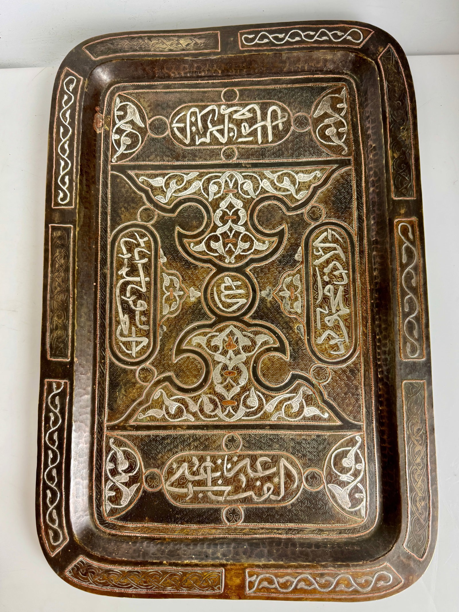 LARGE ISLAMIC SILVER INLAID DISH: Circa 1900. Measures 18.5”x 12”. In good condition. Estimate $10000-1200