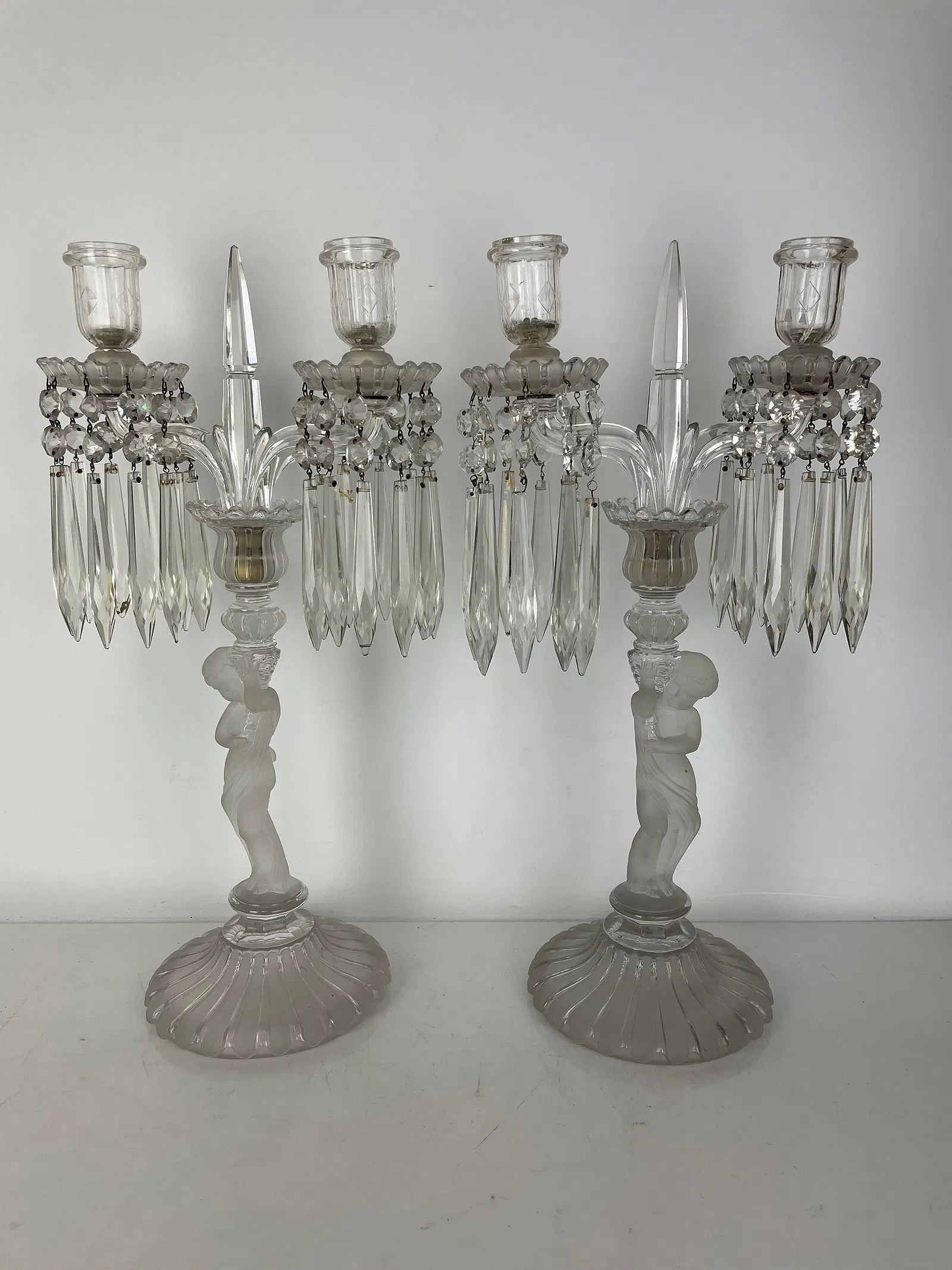 A PAIR OF BACCARAT ENFANT CANDELABRA: Measure 17.5 inches tall. Signed Baccarat. In good condition. Estimate $2500-3000