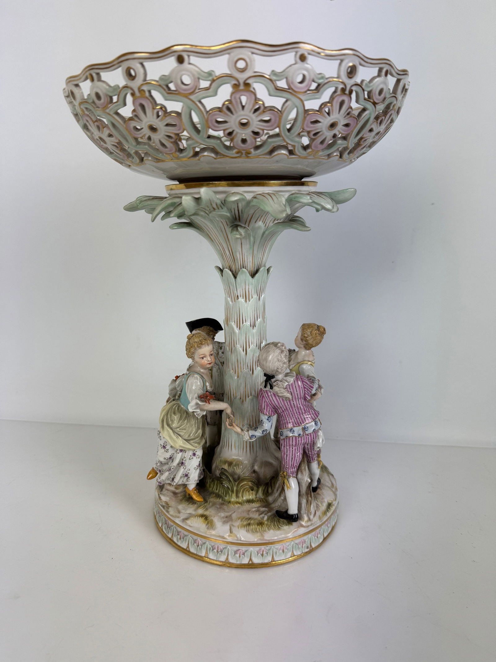 MEISSEN MARRY GO ROUND CENTERPIECE: Circa 1880. Top holds a reticulated plate , 8 inches d., 11 inches tall. In excellent condition. Estimate $2000-2500