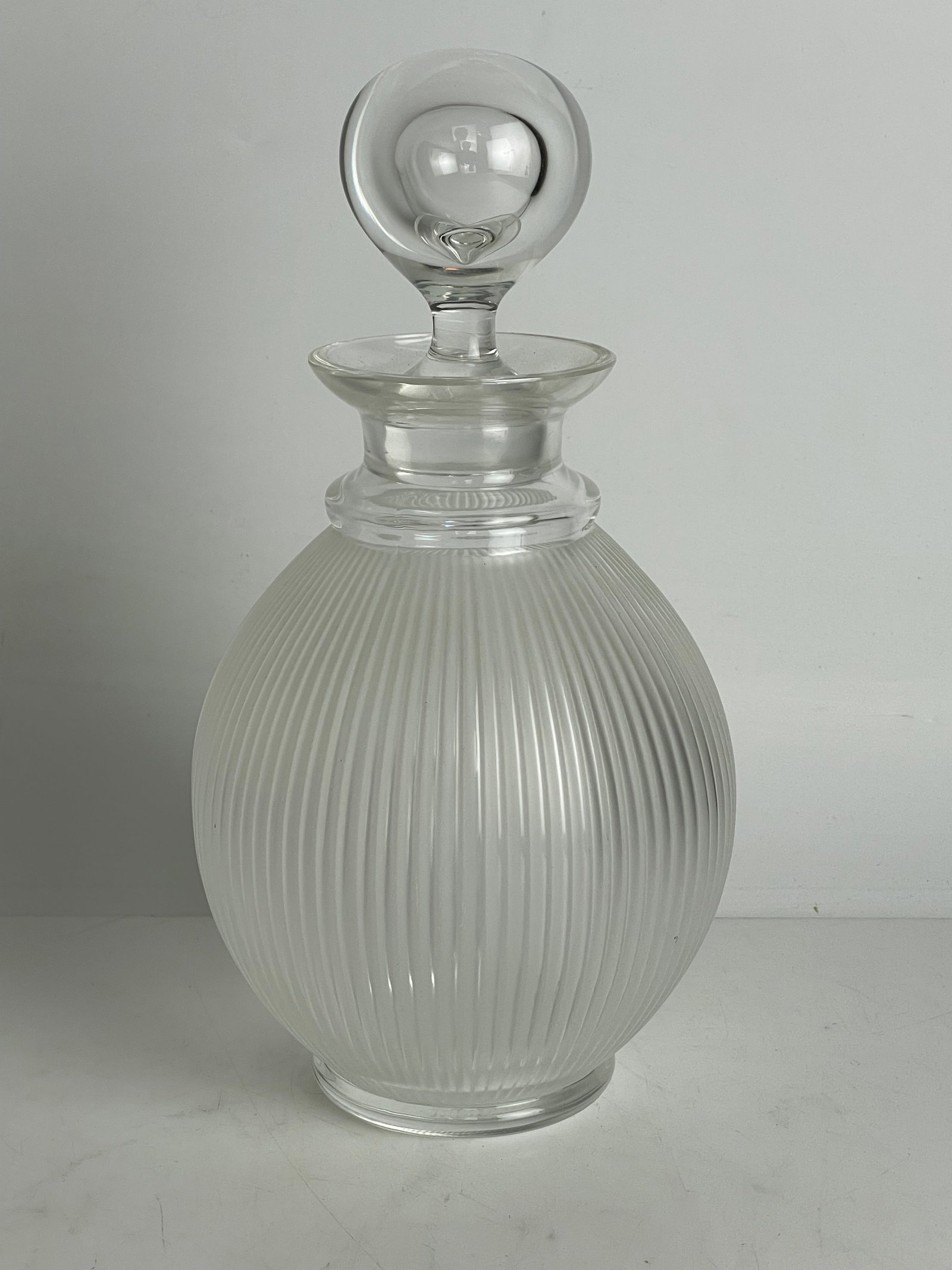 LALIQUE LANGEAIS CRYSTAL DECANTER WITH STOPPER: Measures 10” h. Signed Lalique France. In excellent condition. Estimate $600-800