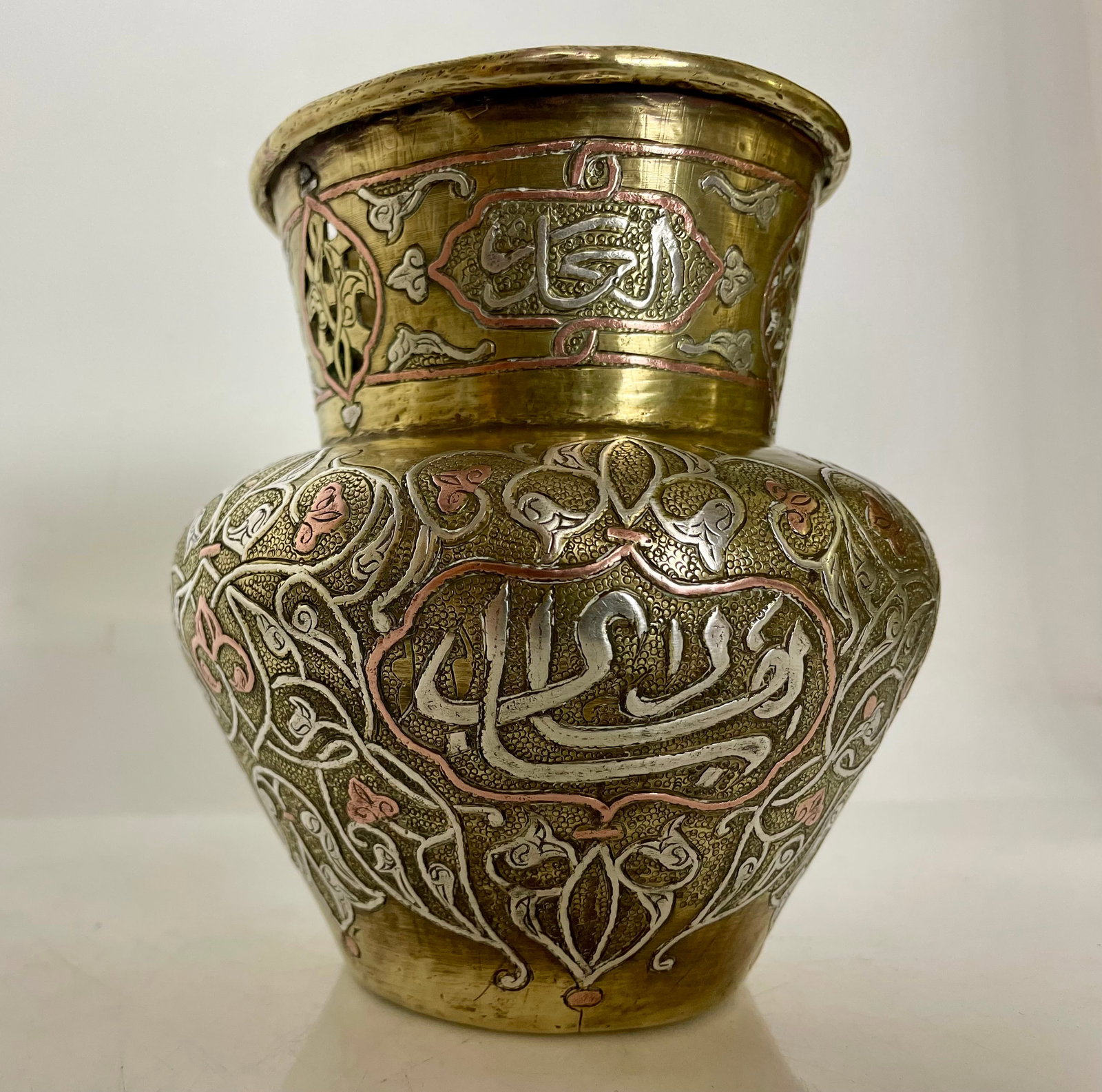 ISLAMIC SILVER INLAID BRASS VASE: Circa 1900. Measures 5” h. Good condition. Estimate $400-500