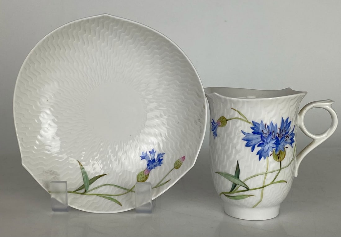 A LARGE MEISSEN CUP AND SAUCER: First quality. In mint condition. Estimate $600-800