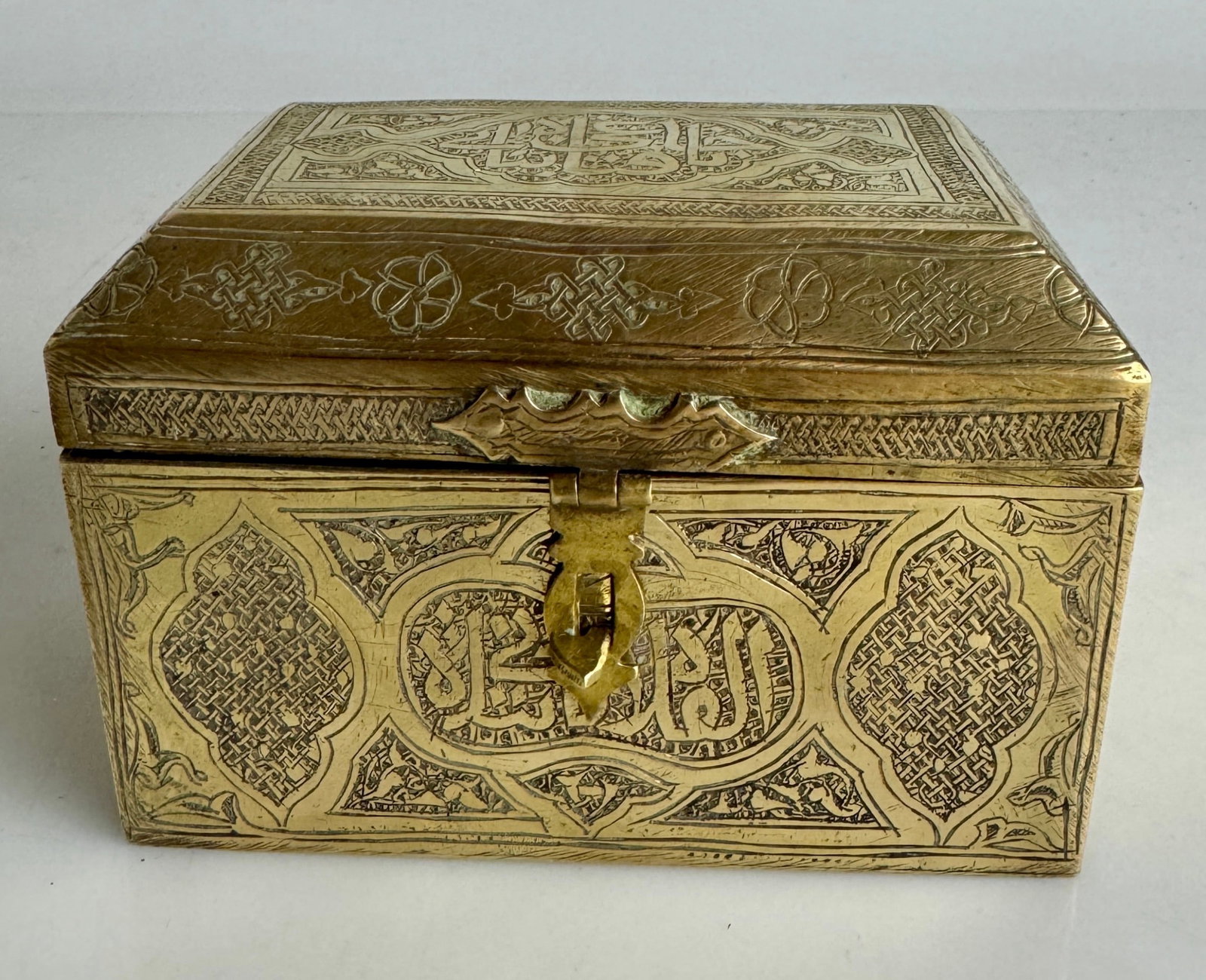 ISLAMIC BRASS BOX: Circa 1900. With Arabic caliagraphy all around the box. Measures 5”x4”x4”. Estimate $400-500