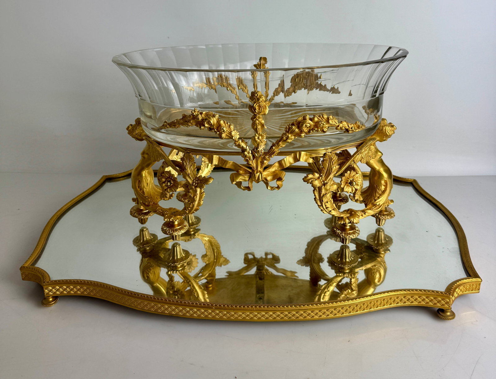 A LARGE ORMOLU AND BACCARAT CRYSTAL CENTERPIECE AND PLATEAU: Circa 1880. Centerpiece measures 15” x 8” x 8”. In excellent condition. Estimate $5000-6000