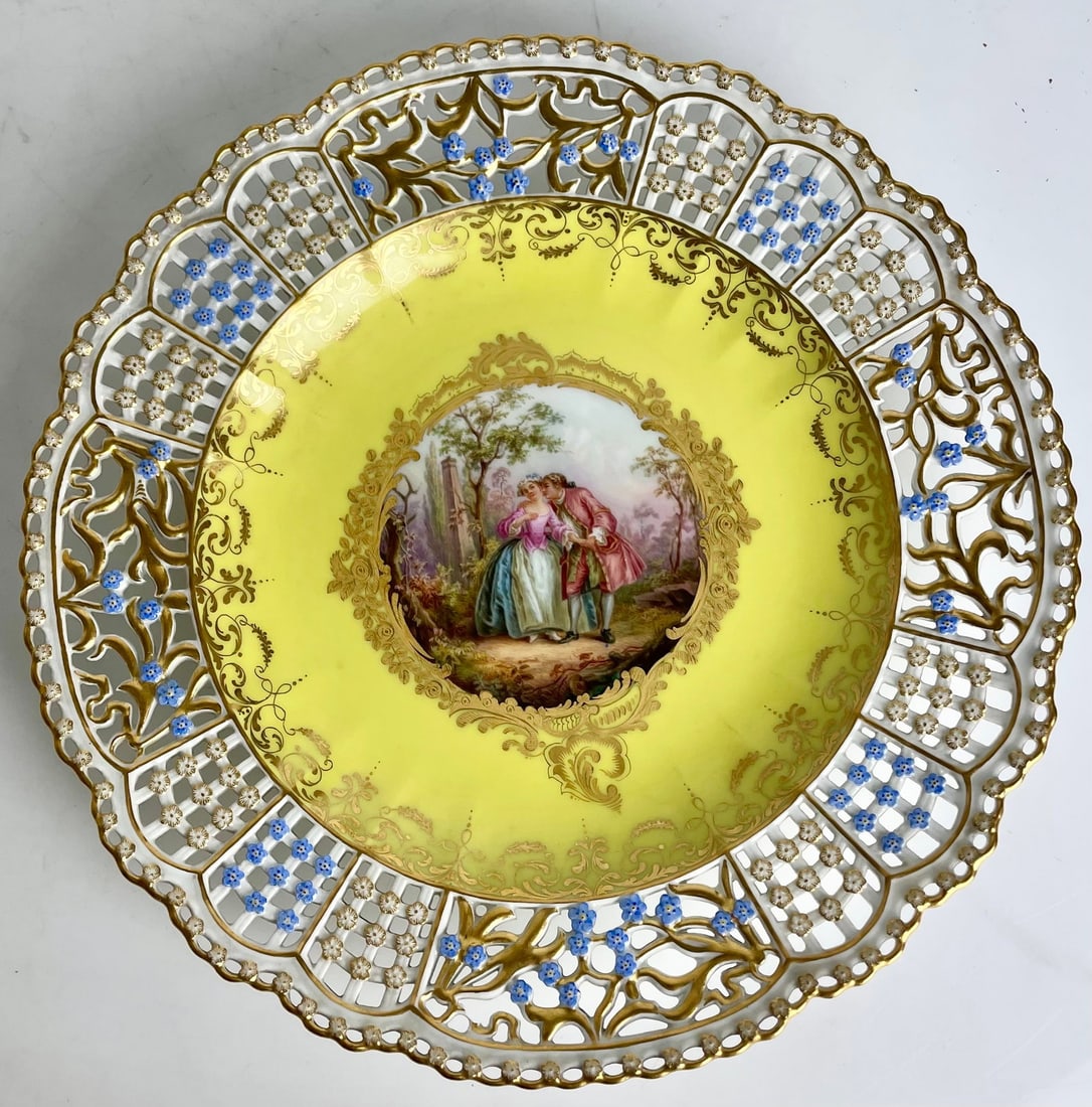 19TH C. MEISSEN YELLOW GROUND RETICULATED PLATE: Painted with Watteau scene . Measures 11” d. In mint condition. Estimate $2500-3000