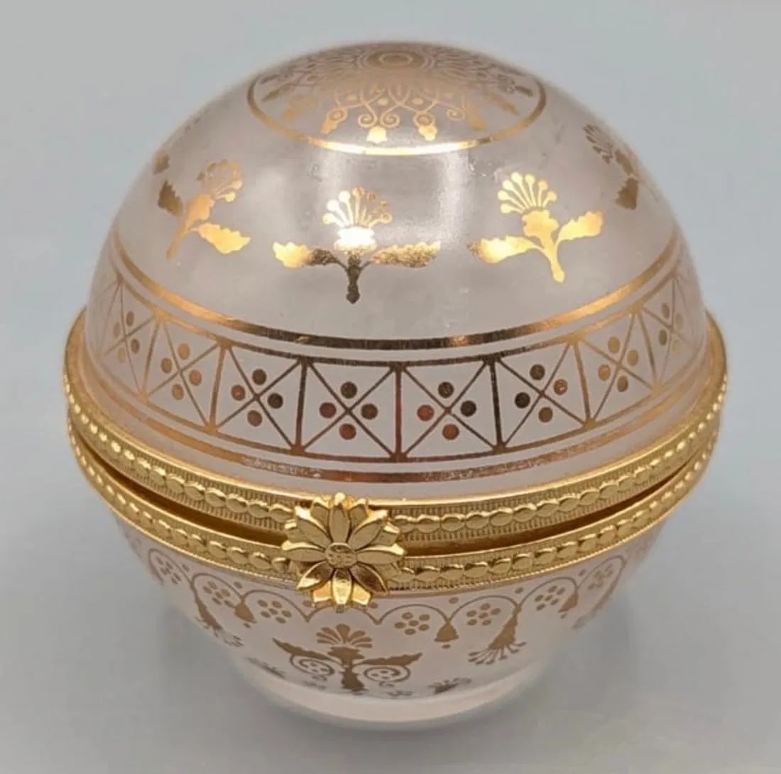 GILT DOME SHAPED BOX: The product is a dome-shaped trinket box from the Estee Lauder Private Collection, created in Japan. Excellent condition. Estimate $150-200