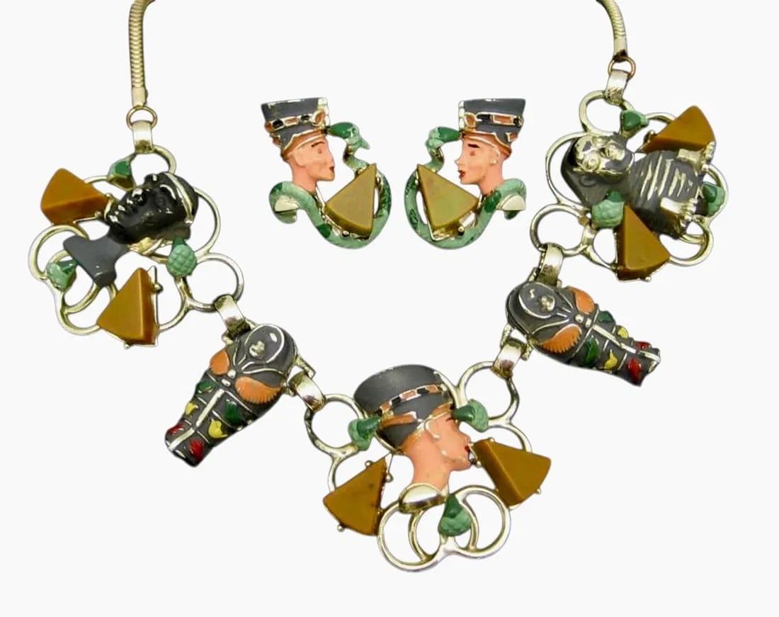 VINTAGE EGYPTIAN REVIVAL BAKELITE JEWLRY SET: Vintage circa 1960, gold plated metal, enamel, bakelite. Necklace and pair of earings.Estimate $1000-1200