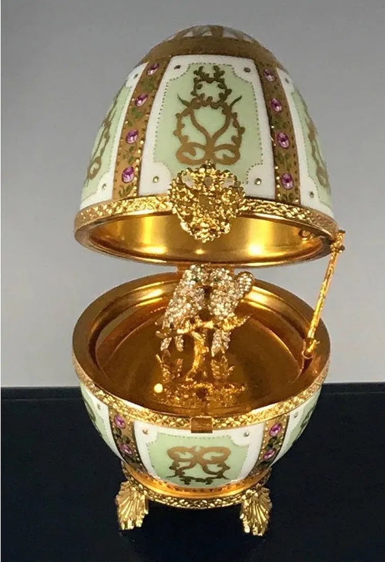 IMPERIAL FABERGE ENAMELED LIMOGE PORCELAIN EGG: Inset with stones, with original box. Good condition. Estimate $800-1.000